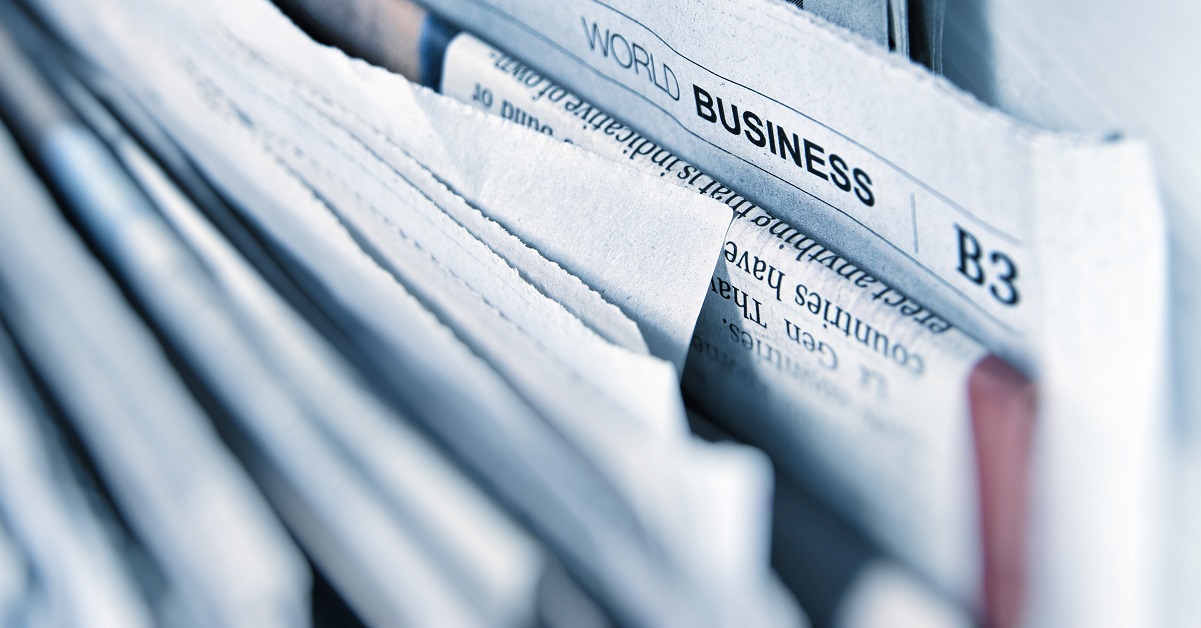 a close up of news papers with the headline world business in focus
