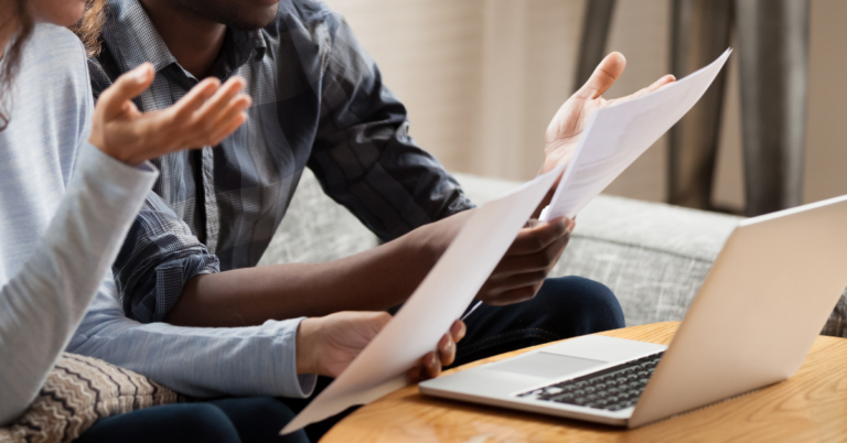 Two people reviewing documents while sitting