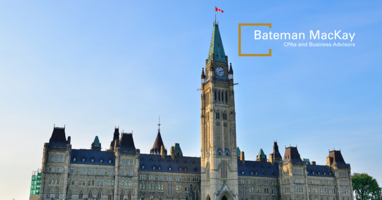 Canadian parliament building with blue sky and bateman mackay logo