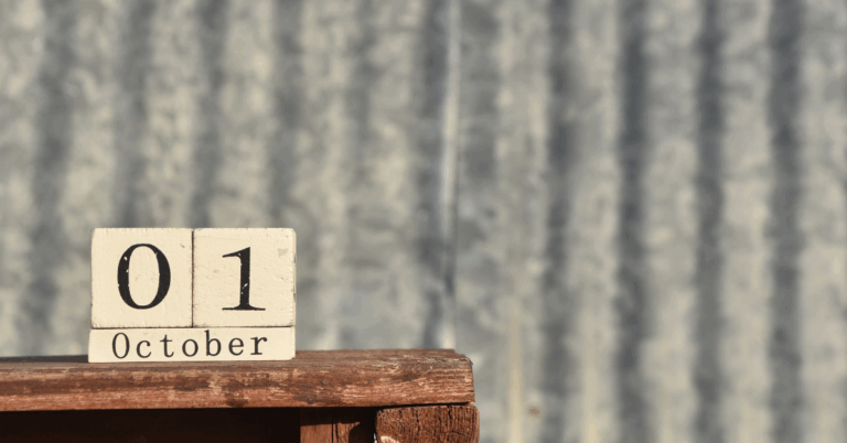 A block calendar on a table displaying October 01