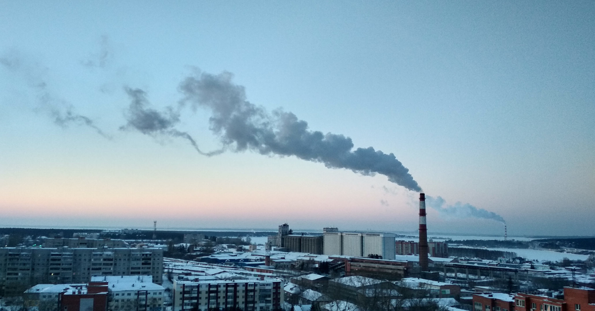 smokestack in a city by the water